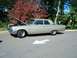 1971 Ford Ranchero - A vintage champagne sedan is parked on asphalt, its hood raised to reveal the engine compartment.
