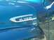 1971 Ford Ranchero - A chrome "F-100" emblem is visible on the side of a teal-colored vehicle.