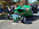 1971 Ford Ranchero - A green hot rod is displayed with its hood and door open, a descriptive board in front.