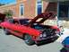 1971 Ford Ranchero - A red muscle car with a black stripe and 'Cobra' text is displayed with its hood open, revealing the engine bay.