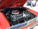 1971 Ford Ranchero - The engine bay of a red vehicle is open, revealing the motor and chrome air cleaner.