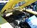 1971 Ford Ranchero - The engine bay of a yellow 1971 Ford Ranchero is open, revealing the Cobra Jet engine and air cleaner assembly.