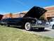 1971 Ford Ranchero - A black 1960 Ford Customline convertible is displayed with its hood open, parked outdoors on a sunny day.