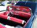 1971 Ford Ranchero - The interior of a classic convertible features red seats with white accents and a red dashboard.