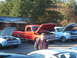 1971 Ford Ranchero - Two classic Ford vehicles, a red pickup and a blue car, displayed with hoods open at an outdoor event.