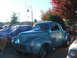 1971 Ford Ranchero - Custom blue coupe hot rod with 'Ford Powered' text and racing graphics parked outdoors.