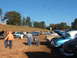 1971 Ford Ranchero - Attendees mill around a collection of vintage automobiles at an outdoor gathering.