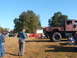 1971 Ford Ranchero - A large military truck is parked at an outdoor event with several other vehicles visible.