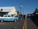 1971 Ford Ranchero - Classic car show scene with multiple vehicles and attendees on a sunny day.