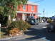 1971 Ford Ranchero - A classic green sedan is parked outside a red brick building on a sunny day.