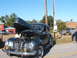 1971 Ford Ranchero - A dark gray coupe, possibly a 1939 model, is displayed with its hood open, revealing the engine compartment.