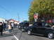 1971 Ford Ranchero - Classic cars are lined up on a street, with people gathered around them at an outdoor event.