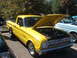 1971 Ford Ranchero - A bright yellow 1971 Ford Ranchero is displayed with its hood open, revealing the engine compartment.