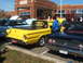 1971 Ford Ranchero - A yellow 1971 Ford Ranchero is parked next to a black car at an outdoor event.