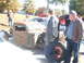 1971 Ford Ranchero - A group of people observe a vintage pickup truck chassis at an outdoor car show.