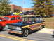 1971 Ford Ranchero - This classic Ford Country Sedan features wood grain paneling and surfboards on its roof rack, parked at an outdoor event.