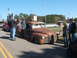 1971 Ford Ranchero - A heavily rusted pickup truck with custom green wheels is displayed at an outdoor event.