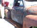 1971 Ford Ranchero - A heavily weathered pickup truck sits on display, its aged bodywork a testament to time.