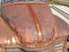 1971 Ford Ranchero - This heavily rusted car hood features a central stripe with pinstripe graphics.