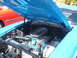 1971 Ford Ranchero - The engine bay of a blue 1970 Ford Ranchero reveals a V8 engine with custom air cleaner and blue spark plug wires.
