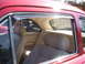 1971 Ford Ranchero - Interior view of a red vehicle, showing tan upholstery and chrome accents.