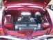 1971 Ford Ranchero - The engine compartment of a vintage automobile is displayed with its hood open, revealing the motor and cooling system.