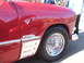 1971 Ford Ranchero - Chrome trim and wire wheel on a red car's fender, with 'Ranchero' script visible.