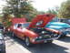 1971 Ford Ranchero - Orange 1970s Ford Ranchero with hood open, parked next to a light blue 1950s Ford truck at an outdoor event.