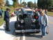 1971 Ford Ranchero - A crowd gathers around a classic car with its hood up at an outdoor event.
