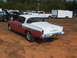 1971 Ford Ranchero - A two-tone coupe with a distinctive chrome side trim is parked outdoors with other vehicles.