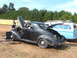 1971 Ford Ranchero - A classic coupe sits with its hood and trunk open, next to a van with surfboards on its roof.