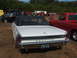 1971 Ford Ranchero - Rear view of a white convertible with a black top, displaying Pontiac badging and a license plate.