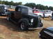 1971 Ford Ranchero - A black 1937 Ford pickup truck is displayed at an outdoor event, parked alongside other vehicles.