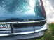 1971 Ford Ranchero - The rear of a dark green Jaguar XJ-S V12 is visible, chrome accents and a license plate.