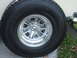 1971 Ford Ranchero - A close-up view of a vehicle's wheel and tire, a distinctive silver multi-spoke rim with a chrome accent.