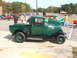 1971 Ford Ranchero - A vintage green pickup truck is parked at an outdoor event with other vehicles.