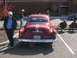 1971 Ford Ranchero - Rear view of a classic red Pontiac sedan, possibly from the early 1950s, with people gathered nearby.