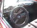 1971 Ford Ranchero - Dashboard and steering wheel of a vintage automobile, a column shifter and round gauges.
