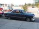 1971 Ford Ranchero - A classic Ford coupe with a distinctive body style is parked curbside next to a red vehicle.