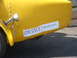 1971 Ford Ranchero - A yellow vehicle is seen from the rear, displaying a "FOR SALE" sign with a contact phone number.