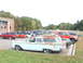1971 Ford Ranchero - Station wagon with surfboards on roof rack, parked in a lot with other vehicles.