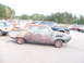 1971 Ford Ranchero - A weathered hot rod coupe sits in a parking lot, surrounded by other vehicles.
