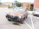 1971 Ford Ranchero - This weathered pickup truck, possibly a Studebaker, is parked in a lot with another vehicle visible.