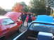 1971 Ford Ranchero - People gather around vehicles with their hoods open at an outdoor event, with autumn foliage visible.