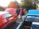 1971 Ford Ranchero - Several people gather around classic vehicles with their hoods open at an outdoor event.