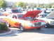 1971 Ford Ranchero - Orange 1971 Ford Ranchero on display with its hood up, parked at an outdoor event.