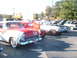1971 Ford Ranchero - A red and white 1956 Ford Fairlane Crown Victoria is parked in a lot with other classic cars.
