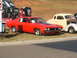 1971 Ford Ranchero - A red 1970 Ford Ranchero is parked next to other vehicles, including a large truck.