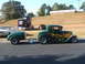 1971 Ford Ranchero - A custom green coupe with flame decals is parked with a trailer, alongside other vehicles.