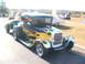 1971 Ford Ranchero - A hot rod with flame graphics is parked outdoors, with other vehicles in the background.
